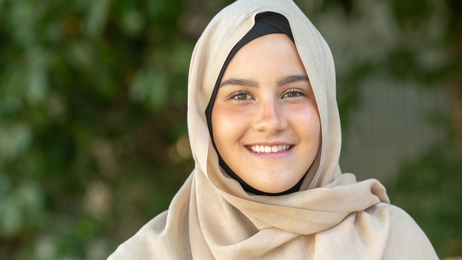 Muslim teenage girl smiling at the camera