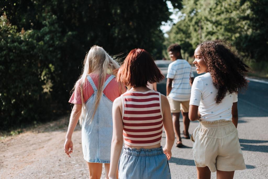 Four teenagers walking down a road